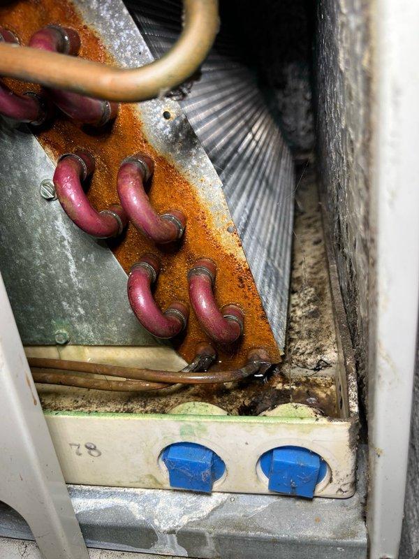 Responded to service call for water leaking from furnace unit. Upon arrival, discovered water leaking from above the furnace and traced source to evaporator coil with drain pan at full capacity. Inspection revealed evaporator drain line was completely blocked with accumulated debris, preventing proper drainage. Cleared blockage by blowing out built-up debris from evaporator drain line, restoring proper drainage function. Verified system operation by testing air conditioning unit, checked refrigerant pressures which were within normal range, and confirmed approximately 15-degree temperature differential across evaporator coil. System returned to normal operation with no further leaking observed.