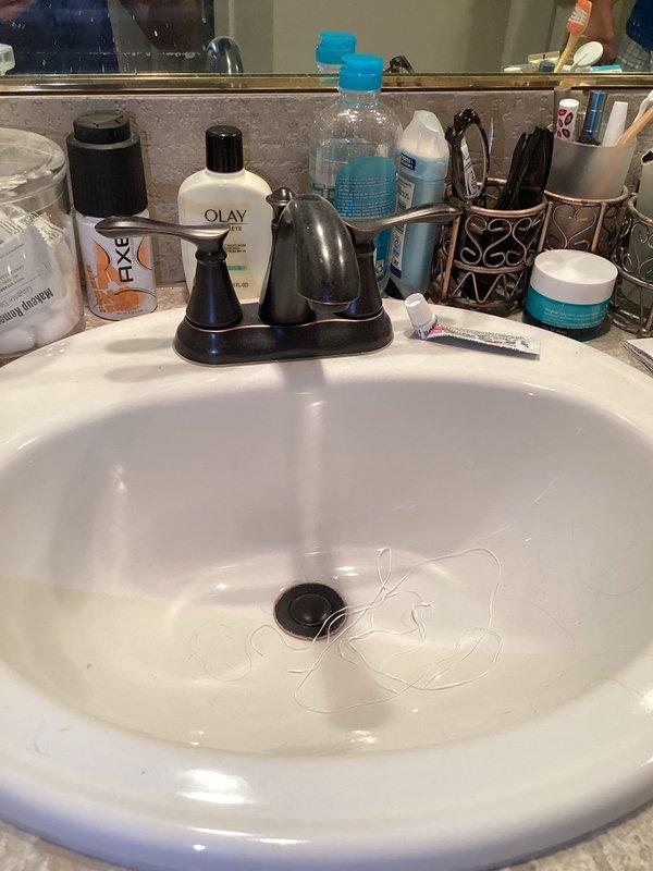 Responded to service call for leaking bathroom faucet and shut-off valves. Replaced worn cartridges in black three-piece faucet assembly and installed new shut-off valves to eliminate all leaks. Tested system for proper operation and verified no additional leaks present upon completion.