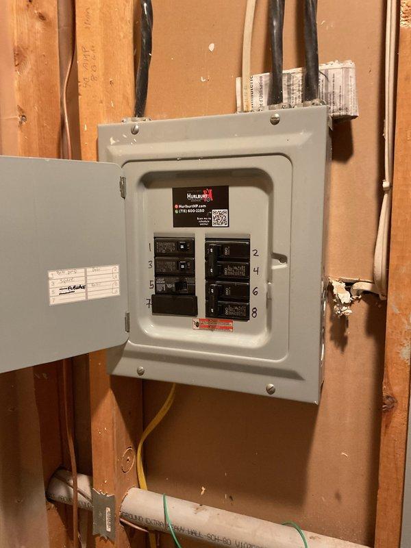 Completed full HVAC system replacement in upstairs closet, installing EL15KC1 2-ton air conditioner (up to 15.9 SEER2, single stage) and matching cased coil with factory-installed TXV valve. Installed new air handler with fresh drain pan and wet puck safety switch. Adapted supply and return plenum connections and concealed refrigerant lines with line hide. Replaced outdoor AC pad, re-leveled with pea gravel, and ran new refrigerant lines to condenser unit. Installed new condensate drain line routed to exterior matching existing configuration.

Upgraded to Honeywell T6 WiFi thermostat and corrected electrical wiring issues discovered during installation. Installed new disconnect switch for air handler and relocated AC disconnect box to meet current code requirements. Secured all exterior electrical conduit and PVC piping to siding with proper mounting brackets. Verified all electrical connections at panel box with eight circuit breakers properly labeled and secured.

System tested and o