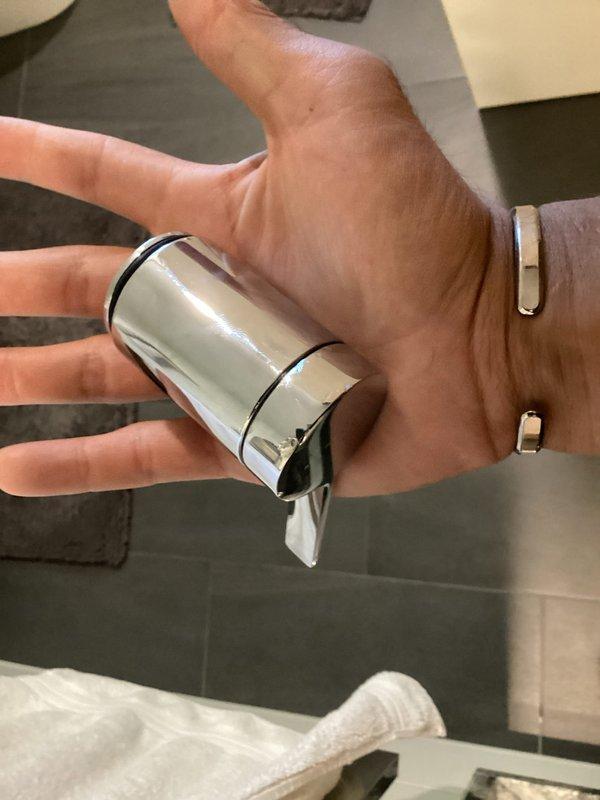 Responded to service call for Kohler shower diverter handle that had fallen off. Upon inspection, determined that the handle had unthreaded itself from the mounting screw. Successfully reset and secured the handle to restore proper operation of the shower diverter assembly.