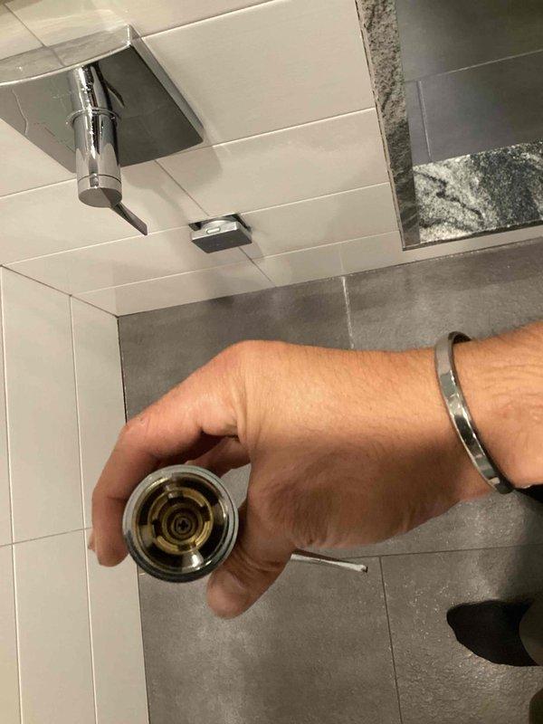 Responded to service call for Kohler shower diverter handle that had fallen off. Upon inspection, determined that the handle had unthreaded itself from the mounting screw. Successfully reset and secured the handle to restore proper operation of the shower diverter assembly.