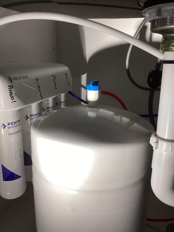 Responded to a leak under the kitchen sink related to a reverse osmosis system installed two days prior. Upon inspection, identified the RO threaded tank valve as the source of the leak. Tightened the tank valve connection, which resolved the leak completely. Performed water quality testing at the kitchen sink to verify system performance: hardness measured at 0 grains per gallon, iron at 0 parts per million, kitchen cold water at 323 total dissolved solids, and RO tap water at 23 total dissolved solids, confirming proper filtration operation.