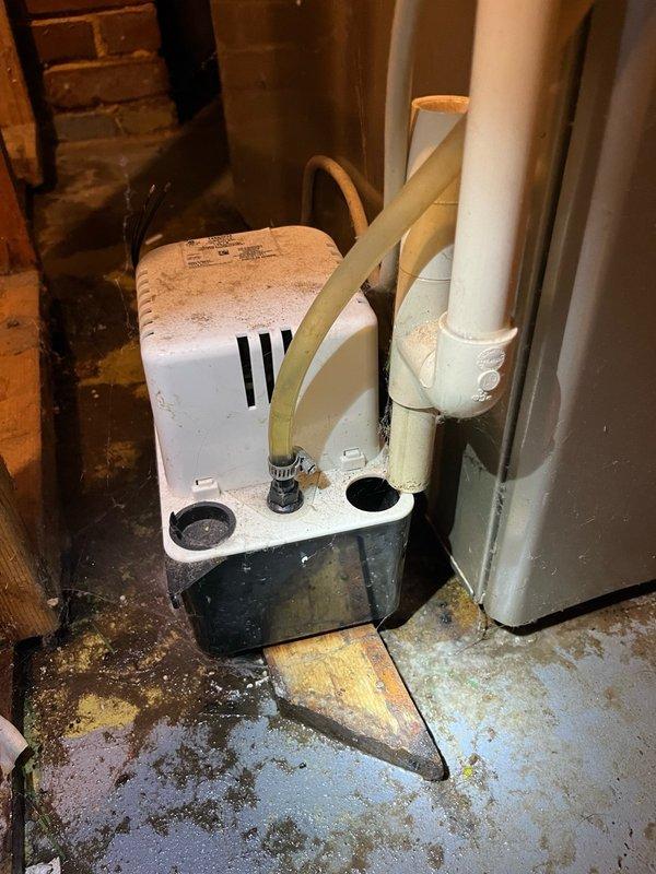 Responded to service call for water leaking from furnace. Upon inspection, found the condensate pump had been displaced from its proper position beneath the furnace and evaporator coil drain. Repositioned the condensate pump to correct location under the drainage point and verified proper alignment with drain lines. Cycled the HVAC system through complete operation to test condensate drainage function. Confirmed all condensate was draining properly into the pump and being discharged correctly. Noted the condensate pump is beginning to show signs of wear with audible noise during operation, which may require future attention. System restored to normal operation with no active leaks present at time of departure.