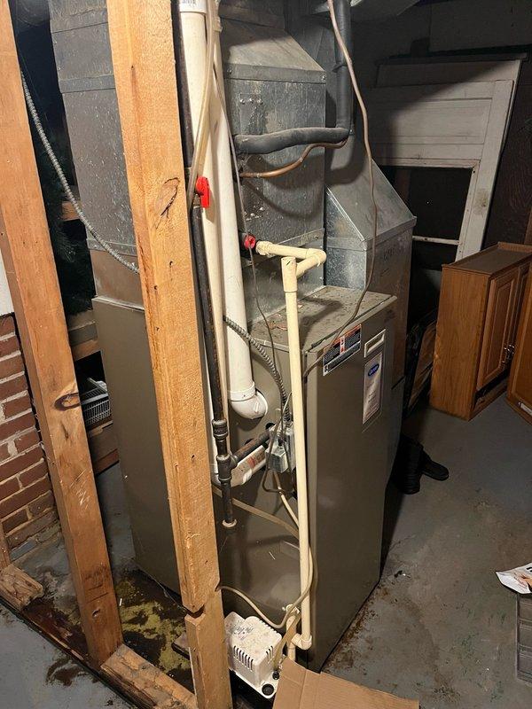 Responded to service call for water leaking from furnace. Upon inspection, found the condensate pump had been displaced from its proper position beneath the furnace and evaporator coil drain. Repositioned the condensate pump to correct location under the drainage point and verified proper alignment with drain lines. Cycled the HVAC system through complete operation to test condensate drainage function. Confirmed all condensate was draining properly into the pump and being discharged correctly. Noted the condensate pump is beginning to show signs of wear with audible noise during operation, which may require future attention. System restored to normal operation with no active leaks present at time of departure.