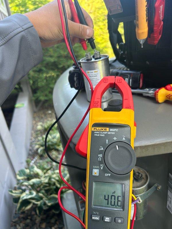 Completed return visit for previously diagnosed HVAC system failure. Installed new large dual capacitor (35+7.5 MFD) and contactor (up to 3-pole, 50 amp) to replace failed components. Verified proper electrical readings with clamp meter, confirmed system operation, and tested cooling functionality to ensure complete restoration of unit performance.