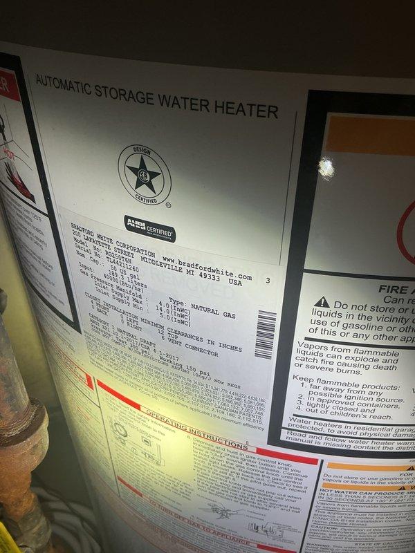 Responded to no hot water complaint and water softener leak in mechanical room. Upon arrival, found water softener drain line missing, causing water to spray throughout the space and extinguish the pilot light on the 40-gallon Bradford White natural gas water heater. Inspection revealed additional leak at the water softener bypass valve. Installed new drain line on water softener, replaced o-rings on bypass assembly to eliminate leak, and successfully relit pilot light on water heater. Verified proper operation of both units before completing service.