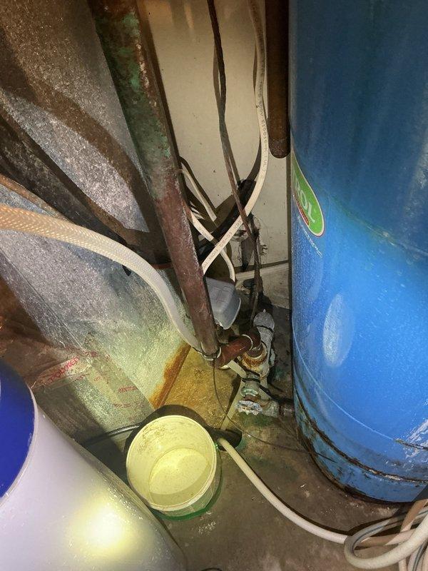 Responded to no hot water complaint and water softener leak in mechanical room. Upon arrival, found water softener drain line missing, causing water to spray throughout the space and extinguish the pilot light on the 40-gallon Bradford White natural gas water heater. Inspection revealed additional leak at the water softener bypass valve. Installed new drain line on water softener, replaced o-rings on bypass assembly to eliminate leak, and successfully relit pilot light on water heater. Verified proper operation of both units before completing service.