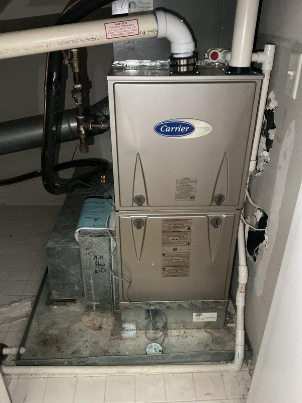 Completed annual cooling maintenance on two 21-year-old air conditioning systems. Main level unit tested within proper specifications with adequate R22 refrigerant levels and all components functioning correctly. Top floor unit found to be low on R22 refrigerant, causing the indoor evaporator coil to freeze and leak water onto the furnace heat exchanger below, with visible water damage observed. Both systems contain obsolete R22 refrigerant. Replaced air filters on both units. Advised that the refrigerant leak and resulting water damage to the heat exchanger could lead to significant furnace damage if left unaddressed. Scheduled same-day estimate for air conditioning system replacement.