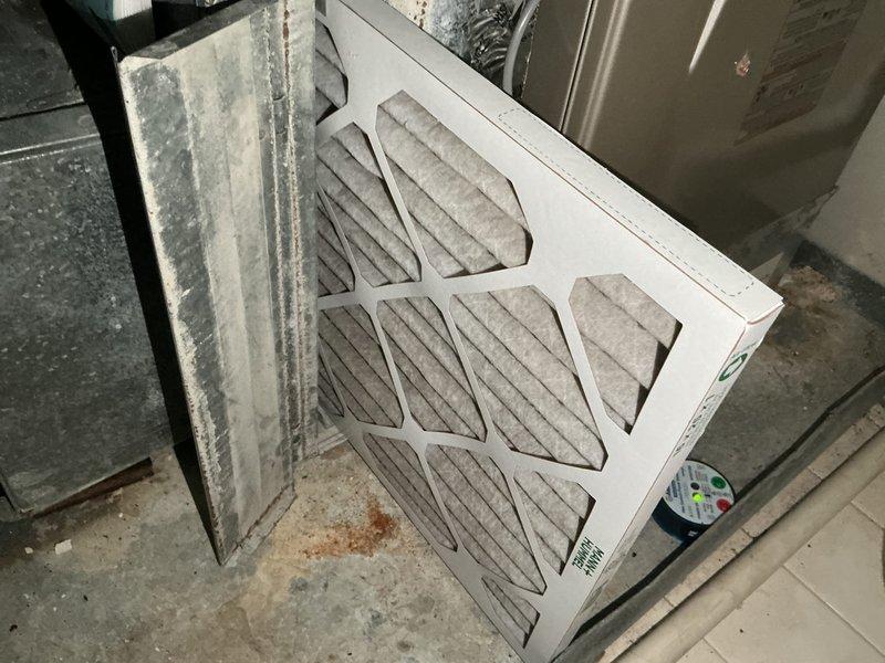 Completed annual cooling maintenance on two 21-year-old air conditioning systems. Main level unit tested within proper specifications with adequate R22 refrigerant levels and all components functioning correctly. Top floor unit found to be low on R22 refrigerant, causing the indoor evaporator coil to freeze and leak water onto the furnace heat exchanger below, with visible water damage observed. Both systems contain obsolete R22 refrigerant. Replaced air filters on both units. Advised that the refrigerant leak and resulting water damage to the heat exchanger could lead to significant furnace damage if left unaddressed. Scheduled same-day estimate for air conditioning system replacement.
