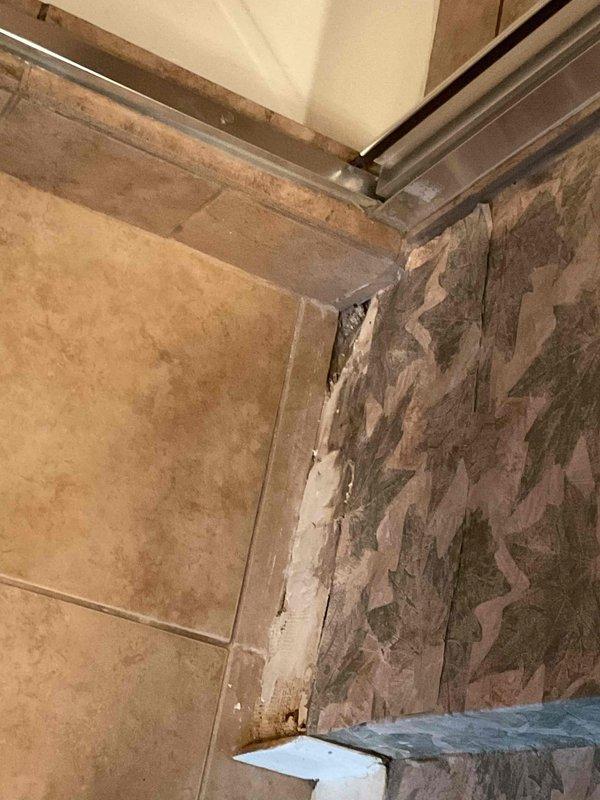 Responded to shower leak occurring during use with water escaping below the floor pan. Upon inspection, identified active leak in shower pan but unable to determine exact source location due to concealed plumbing beneath the floor surface. Documented existing water damage to surrounding wall surfaces showing deterioration, discoloration, and material separation. Coordinated with water damage restoration specialist to perform thermal imaging scan of shower pan to pinpoint leak source for proper repair planning.