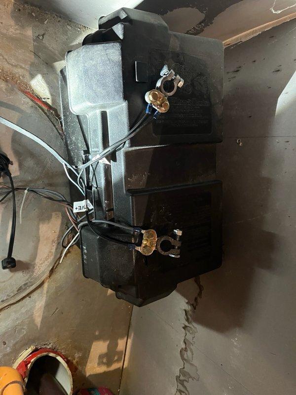 Responded to return visit for non-functional sump pump system with active alarm condition. Upon arrival, diagnosed battery backup system experiencing rapid power drainage after disconnection from charger. Testing confirmed battery charger maintained charge during operation but battery failed to retain adequate voltage when isolated from power source. Inspected primary sump pump assembly with dual brass valve configuration and associated piping connections in basement utility area. Evaluated electrical connections and backup power components. Documented equipment condition through photography for diagnostic purposes. Provided quotation for replacement battery and battery charger assembly to restore proper backup system functionality and resolve alarm condition.