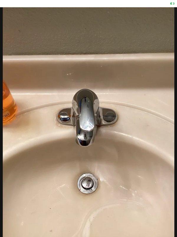 Returned for callback to address lavatory drain issue from previous day's installation. Lavatory strainer plunger was not lifting sufficiently high, causing poor drainage performance. Adjusted pop-up assembly mechanism to increase plunger height, restoring proper drain function. Installation consists of Moen faucet and strainer hardware.
