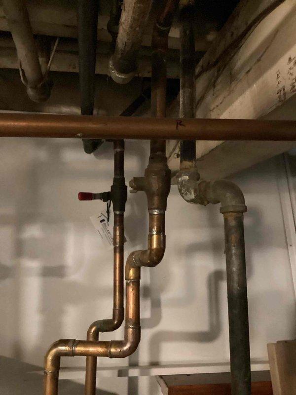 Responded to a no hot water call and found the hot water valve broken off on a 17-year-old 67-gallon natural gas water heater. Upon inspection, discovered the water heater handle was broken and two valves were actively leaking. Due to the age of the unit and extent of the damage, recommended full water heater replacement. Successfully replaced the 67-gallon natural gas water heater with new unit, including installation of new shut-off valves and proper connections to existing copper supply lines. Tested all connections for leaks, verified proper gas combustion, and confirmed hot water delivery throughout the home. Customer also expressed interest in adding an additional outdoor spigot for future consideration.