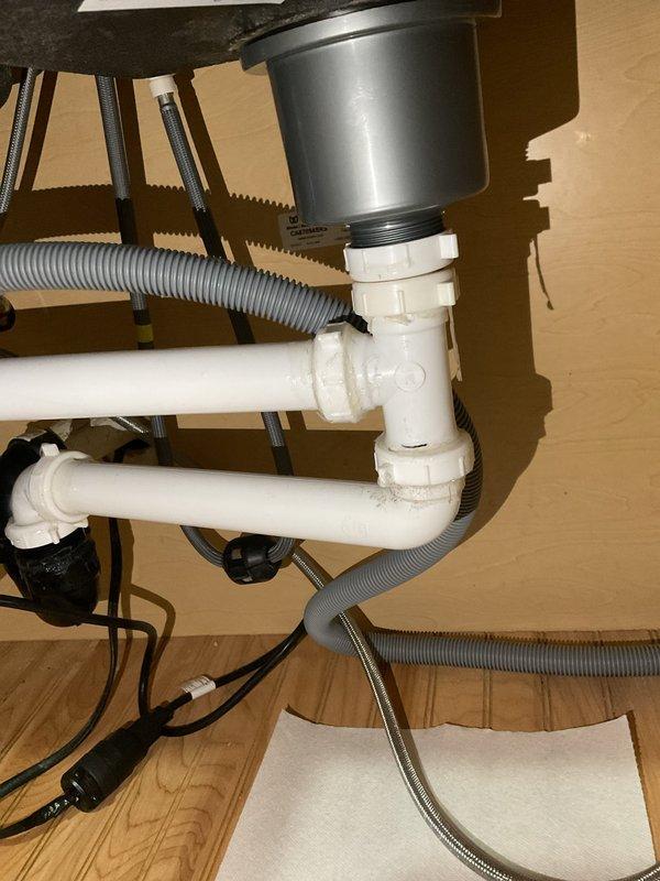 Responded to a water leak under the kitchen sink that was identified during a home inspection. Upon arrival, diagnosed the issue as a missing nut on the tubular drain assembly beneath the sink. Replaced the missing nut and installed a new gasket to restore proper seal and eliminate the leak.