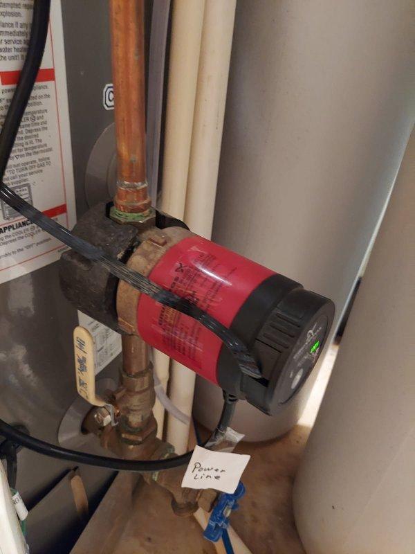 Responded to service call for malfunctioning hot water recirculation system on tanked gas water heater. Upon inspection, diagnosed failed Grundfos recirculation pump that was no longer operating properly. Removed existing pump assembly from copper piping and installed new Grundfos recirculation pump with proper mounting straps and connections. Verified all plumbing connections were secure, tested pump operation, and confirmed proper hot water circulation throughout the system.