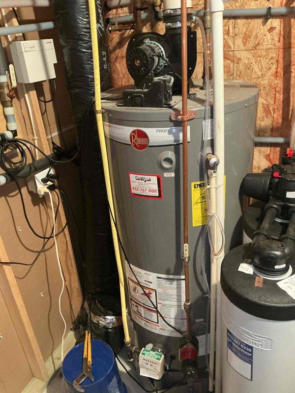 Responded to service call for malfunctioning hot water recirculation system on tanked gas water heater. Upon inspection, diagnosed failed Grundfos recirculation pump that was no longer operating properly. Removed existing pump assembly from copper piping and installed new Grundfos recirculation pump with proper mounting straps and connections. Verified all plumbing connections were secure, tested pump operation, and confirmed proper hot water circulation throughout the system.