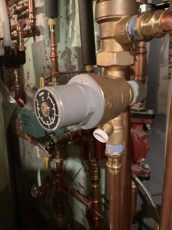 Responded to no hot water complaint on recently installed Navien boiler system. Found boiler pressure at 18 psi due to malfunctioning automatic fill valve preventing water from entering the system. Manually filled boiler to restore proper pressure and functionality, allowing system to produce hot water. Autofill valve requires replacement to prevent future low pressure issues and ensure automatic operation of the system.