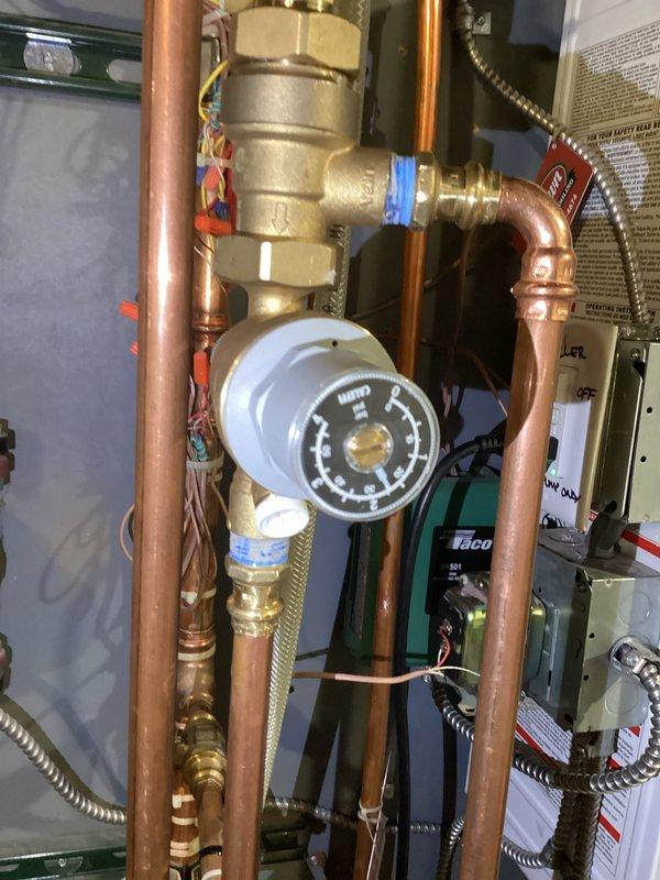 Responded to no hot water complaint on recently installed Navien boiler system. Found boiler pressure at 18 psi due to malfunctioning automatic fill valve preventing water from entering the system. Manually filled boiler to restore proper pressure and functionality, allowing system to produce hot water. Autofill valve requires replacement to prevent future low pressure issues and ensure automatic operation of the system.