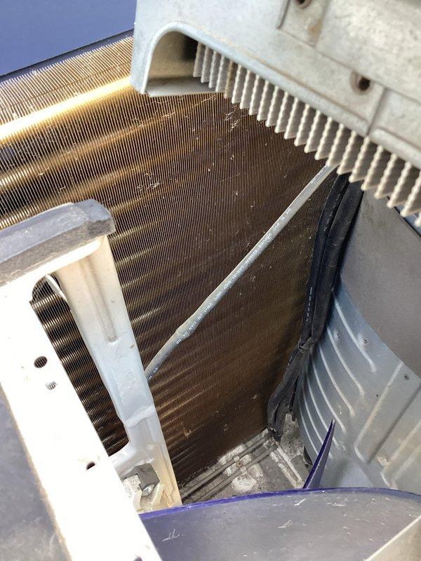 Responded to callback for mini split system not cooling after refrigerant was added during previous service visit. Upon inspection, determined that refrigerant charge only lasted approximately one day, indicating active leak in system. Performed thorough leak detection on both outdoor and indoor unit components, including inspection of copper refrigerant lines, coil assemblies, and connection points. Diagnostics confirmed refrigerant leak is located within the indoor evaporator unit based on rapid loss of charge and visual inspection findings. Provided customer with repair estimate for leak repair and system recharge as backup option while they contact original installing contractor regarding warranty coverage.