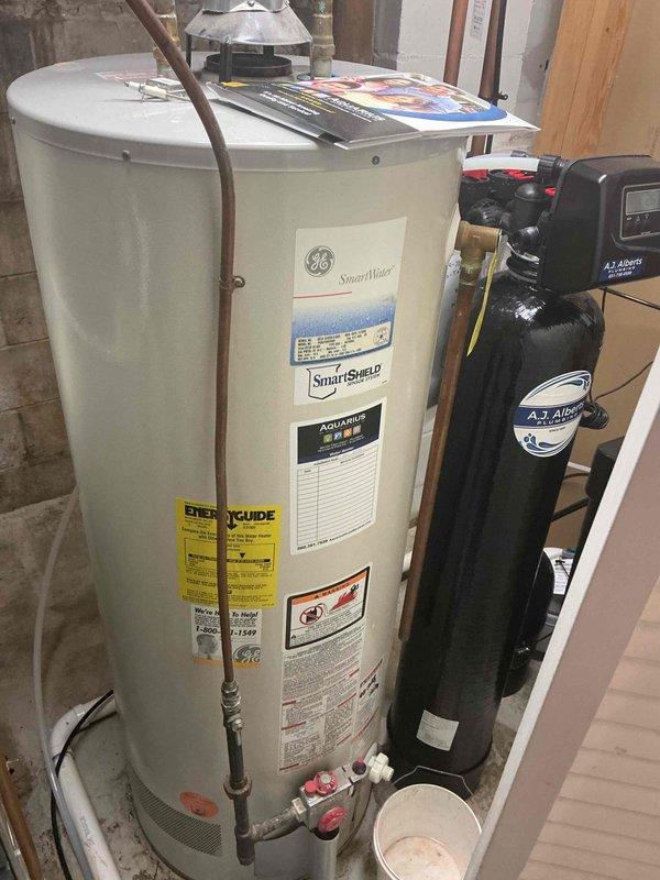 Responded to no-cool complaint with evaporator coil freezing and water leakage above furnace. Upon inspection, found system critically low on refrigerant with low-side pressure dropped from 137 psi (measured during maintenance visit three weeks prior) to 93 psi, indicating significant refrigerant leak likely located in evaporator coil. Observed substantial corrosion in drain pan area and condensate management components. Discussed repair options including leak search, leak repair, and refrigerant recharge versus full system replacement given age and condition of equipment. Customer elected to schedule estimate for complete AC system replacement.