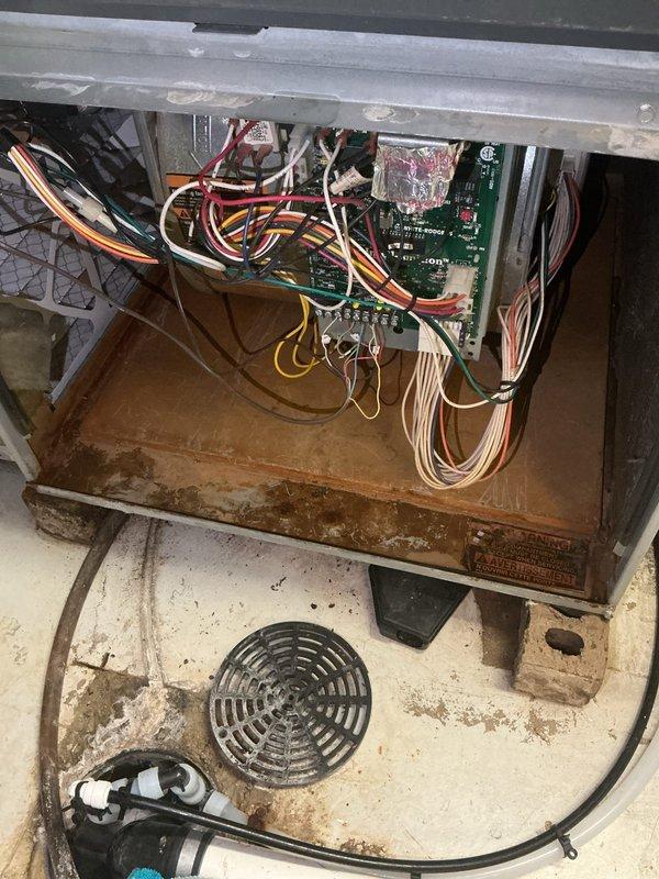 Responded to no-cool complaint with evaporator coil freezing and water leakage above furnace. Upon inspection, found system critically low on refrigerant with low-side pressure dropped from 137 psi (measured during maintenance visit three weeks prior) to 93 psi, indicating significant refrigerant leak likely located in evaporator coil. Observed substantial corrosion in drain pan area and condensate management components. Discussed repair options including leak search, leak repair, and refrigerant recharge versus full system replacement given age and condition of equipment. Customer elected to schedule estimate for complete AC system replacement.