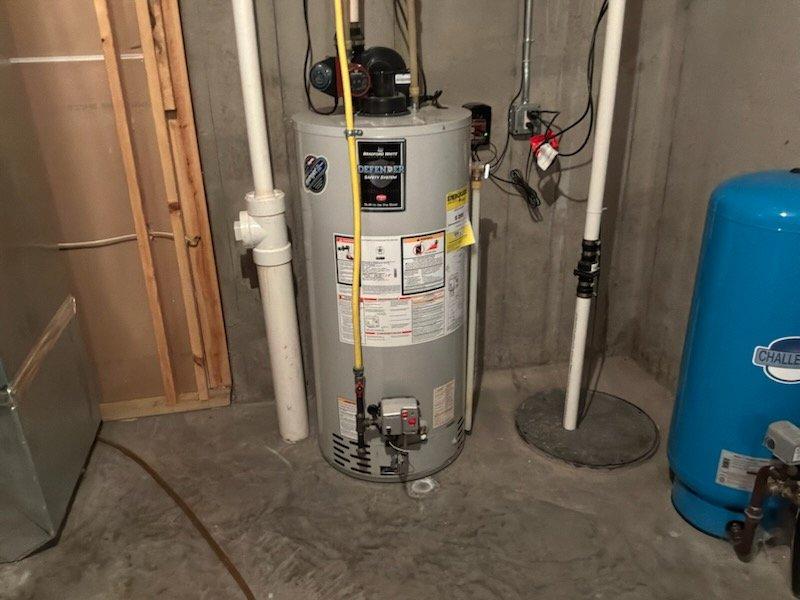 Responded to service call for leaking natural gas water heater in basement utility area. Upon inspection, confirmed water heater was actively leaking from drain valve and unit showed signs of age-related deterioration. Homeowner requested full replacement rather than repair. Removed existing water heater and installed new 50-gallon natural gas tank-type water heater. Connected all supply and discharge plumbing lines, installed temperature and pressure relief valve with proper discharge piping, and reconnected gas line with appropriate fittings and shutoff valve. Tested all connections for leaks, verified proper venting, and confirmed unit operation and temperature settings before completing installation.