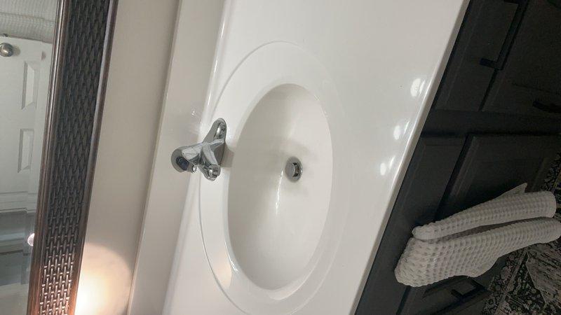 Completed comprehensive plumbing inspection for residential property sale, evaluating all faucets, fixtures, pipes, drains, toilets, and shut-off valves throughout the home. Inspected half bath and full bath for proper toilet function, seal integrity, and flush mechanisms, with specific attention to upstairs laundry closet area for potential leak concerns and adequate shut-off valve accessibility. Verified kitchen plumbing system functionality, exterior hose bib operation, and documented all findings with photographic evidence of bathroom fixtures and components.