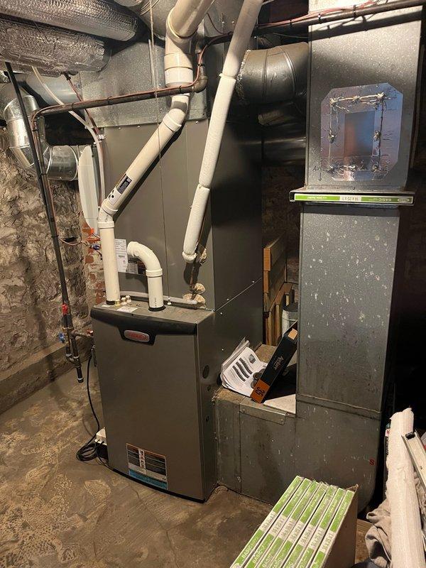 Completed annual AC tune-up on 3-year-old system under maintenance agreement. Addressed customer concern regarding water accumulation near furnace, which was determined to be caused by humidifier operating during cooling season. Replaced air filter, performed comprehensive inspection of all system components including electrical connections, refrigerant levels, condensate drainage, and airflow, with all measurements within manufacturer specifications. System tested for 15 minutes showing proper operation with temperature split exceeding 22 degrees across evaporator coil. Advised customer to monitor area with humidifier remaining off and confirmed no further water issues since deactivation. System operating efficiently and ready for cooling season.