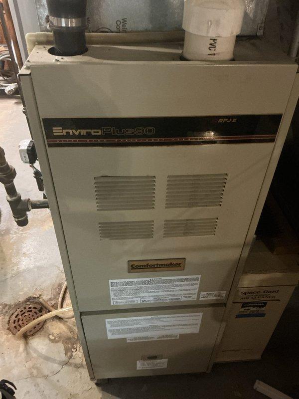 Responded to no cooling complaint on 31-year-old air conditioning system. Upon inspection, found failed condenser fan motor and failing capacitor with 5-7 day lead time on replacement parts. System utilizes obsolete refrigerant with potential for additional underlying issues. During evaluation, discovered cracked heat exchanger in EnviroPlus80 Comfortmaker furnace located in top right cell through high limit switch eyelet, causing carbon monoxide leakage outside unit during operation. Immediately red-tagged furnace as unsafe to operate and applied lockout/tagout procedures to gas supply valve. Documented critical safety hazard with photographic evidence. Scheduled same-day estimate appointment for new air conditioning system and provided options for complete HVAC system replacement given age of equipment and severity of safety concerns. Replaced condenser fan motor, heat exchanger, and complete air conditioning system to restore safe, efficient operation.