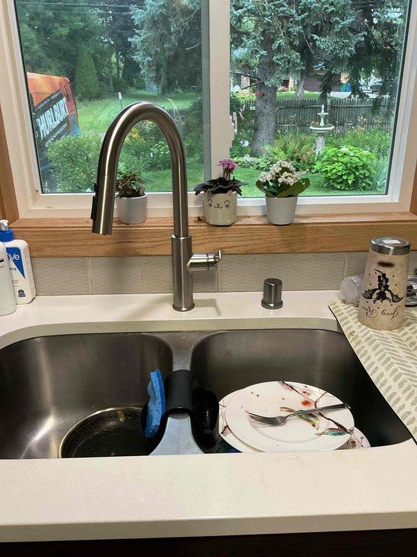 Installed new brushed stainless steel kitchen faucet with high arched spout at single-family residence. Connected faucet supply lines to existing shutoff valves and verified proper water flow and drainage through double-basin stainless steel sink. Cleared basement toilet obstruction using closet auger, restoring proper flush function and drainage.
