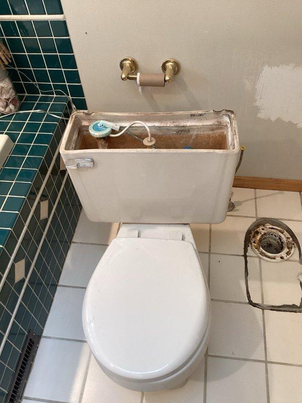 Responded to service call for toilet reseating evaluation. Upon arrival, removed toilet to inspect subfloor mounting system and discovered severely deteriorated toilet flange with visible cracking and extensive rust corrosion around mounting holes. The PVC flange exhibited structural damage and compromised integrity due to age and water exposure. Documented existing conditions through photography showing corroded flange, deteriorated mounting surface, and surrounding concrete substrate damage. Provided comprehensive estimates covering three options: repair and replacement of damaged toilet flange with reinstallation of existing toilet fixture, complete flange replacement with new toilet installation, and assessment of subfloor conditions requiring remediation prior to fixture reinstallation. Explained that proper flange replacement would require removal of damaged component, cleaning of drain pipe connection, installation of new flange assembly with secure fastening to subfloor, new wa