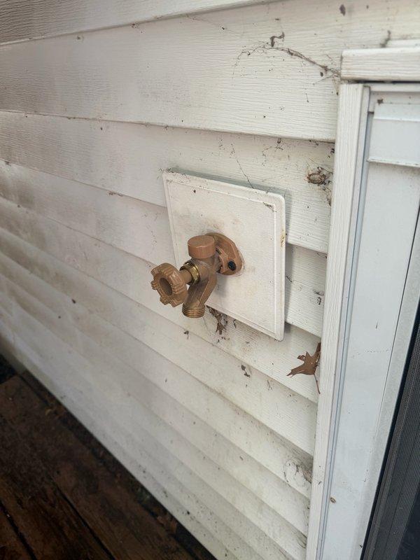 Replaced failed exterior hose bib with new brass frost-free spigot assembly mounted to vinyl siding. During installation, discovered kitchen sink basket strainer had developed a minor leak and replaced it along with installing a new kitchen faucet. All fixtures tested and verified operational with no leaks detected.