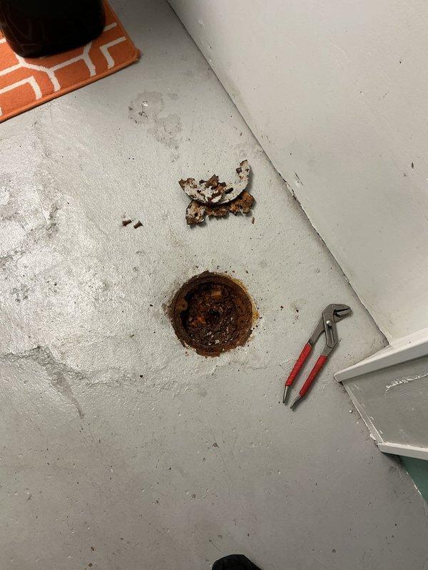 Responded to service call for malfunctioning floor drains at commercial property. Upon inspection, identified two separate issues requiring immediate attention: first floor drain missing functional cleanout cap, second floor drain completely obstructed with accumulated rust debris.

Installed new cleanout cap on first floor drain and performed operational testing to ensure proper sealing and functionality. Addressed second floor drain by removing grate assembly to access blockage. Found drain bowl filled with heavy rust accumulation preventing water flow. Removed rust debris using vacuum extraction method to clear basin area.

Performed mechanical cable cleaning of affected drain line to restore flow capacity and remove any remaining obstructions in the pipe. Successfully cleared blockage and verified line was flowing properly. Conducted final testing by flushing multiple buckets of water through both floor drain systems to confirm complete restoration of drainage function and proper o