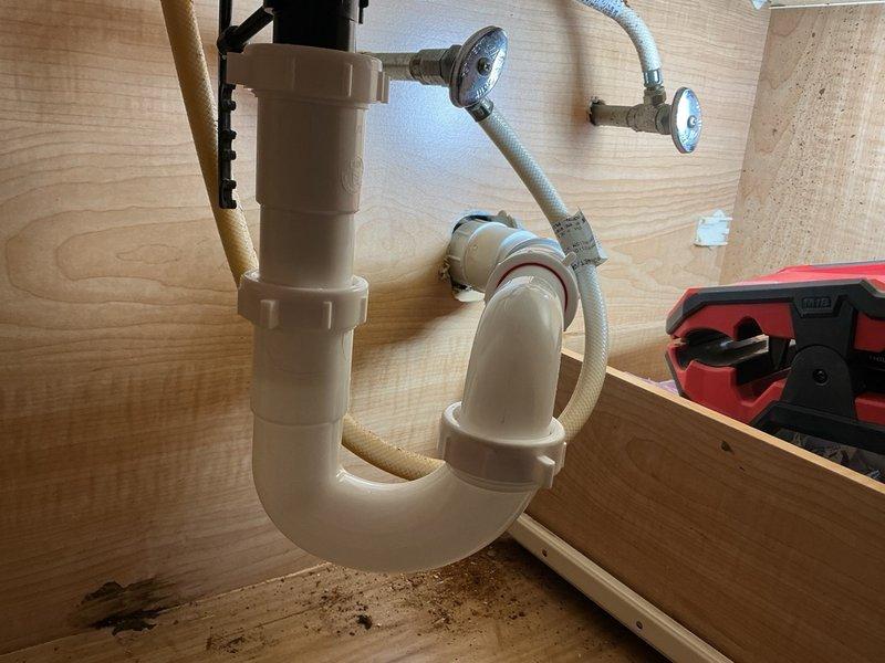 Responded to a plugged bathroom sink drain issue. Upon arrival, disassembled the P-trap and drain piping beneath the vanity to access the blockage. The drain line was severely clogged with debris. Cleared the obstruction using a small rigid snake machine, ensuring proper flow was restored throughout the drain system. Reassembled and reconnected all piping components beneath the sink, including the P-trap assembly and tailpiece connections. Verified all connections were secure with no leaks and confirmed proper drainage function before completing the service.