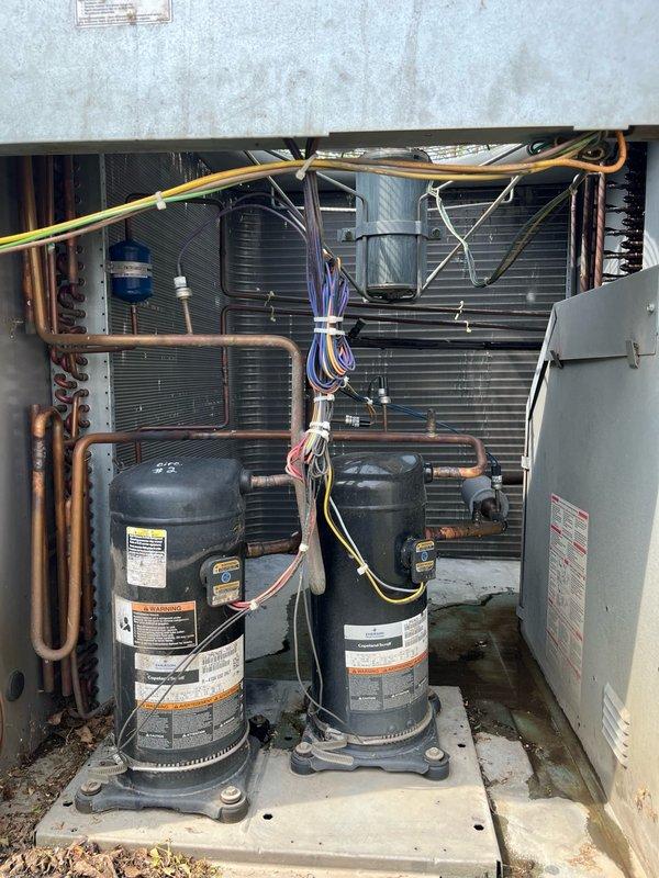 Performed comprehensive cleaning service on seven rooftop and split system units at commercial facility. Washed condenser coils on five RTUs without chemical application to restore proper heat transfer and system capacity, completing work without requiring unit disassembly. Additionally cleaned two residential-style split systems serving office spaces. Inspected dual compressor configurations, refrigerant lines, and electrical connections during service. Verified proper operation of all units following cleaning procedures. All equipment tested and confirmed operational upon completion.