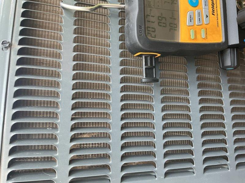 Responded to no-cool complaint on 6-year-old system for second opinion after another company reported rodent damage and low refrigerant. Upon arrival, thermostat was at setpoint of 72°F. Performed comprehensive system evaluation including air filter inspection, blower motor operation, outdoor unit coil condition, capacitor, contactor, and refrigerant charge verification. Located wire damage from rodent activity at outdoor unit; confirmed damage was limited to protective sleeve only with conductors intact. Secured exposed wiring with electrical tape. Measured supply/return air temperature delta at 19°F, confirming proper system performance. All components operating within normal parameters with no refrigerant loss detected. Explained that previous temperature issues likely resulted from extreme outdoor conditions (90°F+), heat gain from kitchen activities, and inadequate ductwork coverage to home addition near thermostat location rather than equipment malfunction. System operating prope