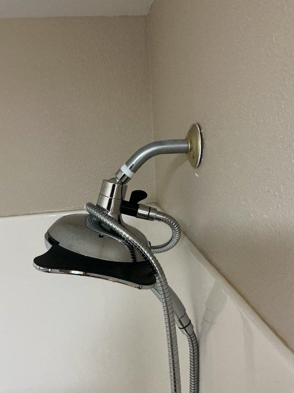 Responded to a dripping shower complaint and diagnosed a faulty shower cartridge as the source of the leak. Removed the existing chrome shower handle assembly, extracted the defective cartridge, and installed a new replacement cartridge to restore proper function and eliminate the water leak.