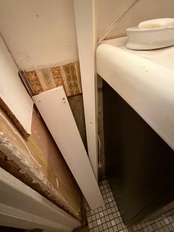 Responded to emergency water leak affecting multiple floors with active water intrusion from second floor through walls into basement. Located source of leak as failed 3/8" copper supply line within wall cavity servicing upstairs bathroom. Instructed homeowner to shut off main water supply to stop active flooding. Accessed wall cavity, isolated compromised copper line, and permanently capped supply lines to upstairs bathroom to eliminate leak source. Documented extensive water damage to drywall, wall surfaces, and bathroom fixtures. Advised homeowner to contact water restoration company for remediation of moisture damage throughout affected areas.
