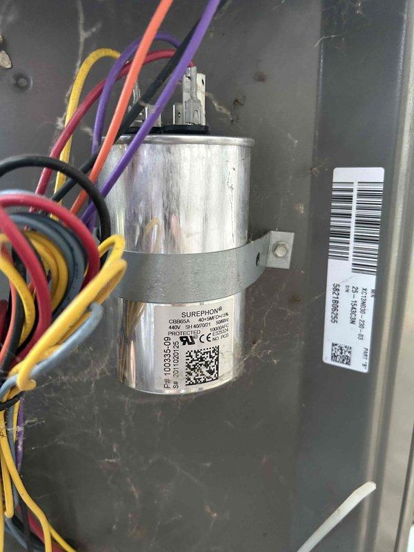 Responded to no cooling call on 3-year-old residential AC system. Upon arrival, found outdoor unit inoperative with evidence of catastrophic compressor failure - customer reported loud popping noise followed by black liquid discharge from unit. Inspection confirmed compressor had mechanically failed and blown out a retaining pin, rendering system unable to operate. Documented equipment condition with photos showing outdoor condensing unit and internal electrical components including capacitor. Advised customer of compressor failure and initiated warranty claim process given unit is well within 10-year parts coverage period.
