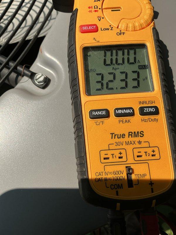 Completed preventive maintenance visit on 10-year-old residential air conditioning system. Discovered dirty condenser coil and failed dual capacitor during inspection. Replaced defective dual capacitor with new component, restoring proper system operation. Tested capacitance readings with multimeter to verify correct values (32.33 μF). System returned to normal operating condition with all components functioning within manufacturer specifications.