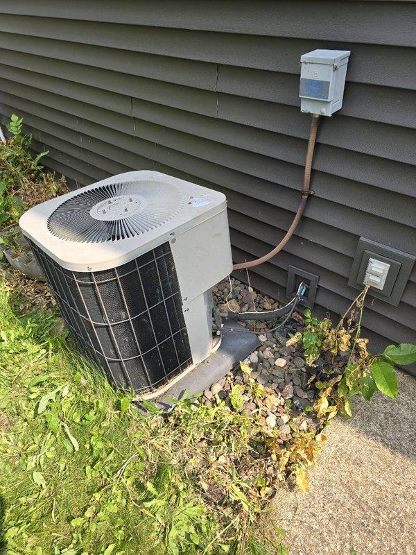 Responded to no cooling call on 27-year-old central air conditioning system. Upon arrival, found outdoor condenser unit buzzing but not running, with breaker tripped. Reset breaker and performed diagnostic testing on all major components. Compressor attempted to start but failed to run, drawing high amperage during start attempts. Installed hard start capacitor to assist compressor starting, but unit still failed to operate properly. Compressor determined to be mechanically failing and unable to achieve full operation even with hard start assistance. Due to age of system and extent of compressor failure, provided customer with options for replacement system pricing alongside repair estimates for next steps decision.