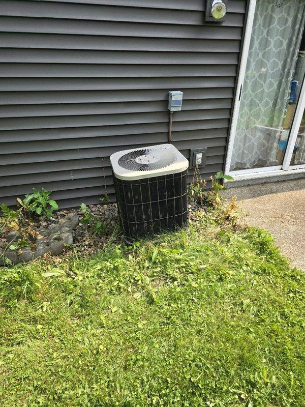 Responded to no cooling call on 27-year-old central air conditioning system. Upon arrival, found outdoor condenser unit buzzing but not running, with breaker tripped. Reset breaker and performed diagnostic testing on all major components. Compressor attempted to start but failed to run, drawing high amperage during start attempts. Installed hard start capacitor to assist compressor starting, but unit still failed to operate properly. Compressor determined to be mechanically failing and unable to achieve full operation even with hard start assistance. Due to age of system and extent of compressor failure, provided customer with options for replacement system pricing alongside repair estimates for next steps decision.