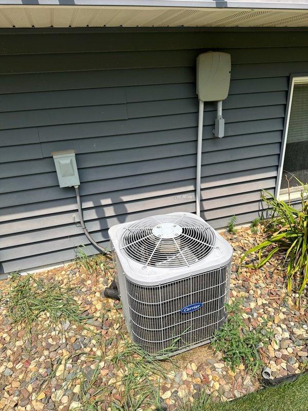 Responded to no-cool condition on 13-year-old residential air conditioning system where indoor unit circulated air but outdoor condenser unit failed to operate, producing only humming/hissing sound. Upon inspection, diagnosed failed dual capacitor testing significantly out of manufacturer specifications and condenser fan motor with visible oil leakage indicating bearing failure. Successfully replaced both dual run capacitor and condenser fan motor, restoring full system operation.