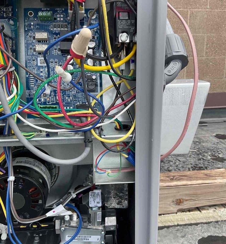Responded to phone follow-up regarding water accumulation in HVAC drain pan. Inspected unit interior components, control board, wiring connections, and drainage system. Documented current system condition with photos of electrical panel and internal components for customer records and provided technical guidance to address drainage concern.