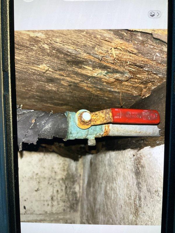 Responded to callback following city inspector's concern about potential plumbing leak in cellar. Conducted thorough inspection of all piping, including previously serviced hose bib backflow prevention device and main shut-off valve. Found no active leaks present; all previous repairs remain watertight and functioning properly. Observed significant condensation accumulation on cellar pipes throughout the space. Documented conditions with photographs showing ball valves, copper piping connections, and moisture presence on supply lines. Confirmed condensation is environmental issue related to temperature differential and humidity levels, not plumbing failure requiring repair.