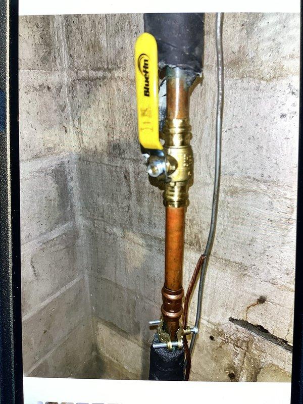 Responded to callback following city inspector's concern about potential plumbing leak in cellar. Conducted thorough inspection of all piping, including previously serviced hose bib backflow prevention device and main shut-off valve. Found no active leaks present; all previous repairs remain watertight and functioning properly. Observed significant condensation accumulation on cellar pipes throughout the space. Documented conditions with photographs showing ball valves, copper piping connections, and moisture presence on supply lines. Confirmed condensation is environmental issue related to temperature differential and humidity levels, not plumbing failure requiring repair.