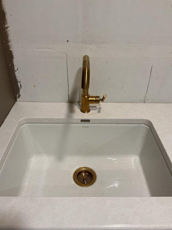 Responded to low water pressure complaint at pantry faucet, which was the only affected fixture in the home. Diagnosed issue as malfunctioning faucet sprayer with stuck/broken button mechanism causing restricted flow to main spout. Advised customer to contact faucet manufacturer for replacement sprayer component, as the faucet body and supply lines were functioning properly.