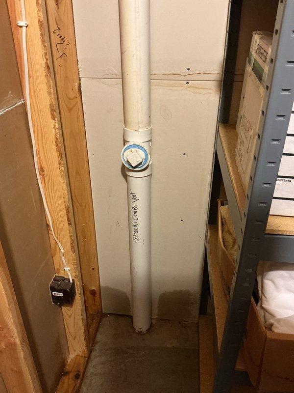 Responded to main drain backup caused by plugged inlet on sewer tank. Cleared blockage by breaking up accumulated toilet paper at inlet, restoring proper drainage and flow to the system.