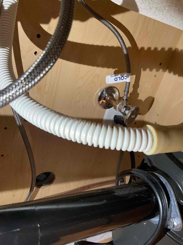 Responded to a water leak under the kitchen sink and successfully replaced a faulty angle stop valve and supply line. The old angle stop was leaking and causing water damage, so new components were installed to restore proper function and prevent further leakage.
