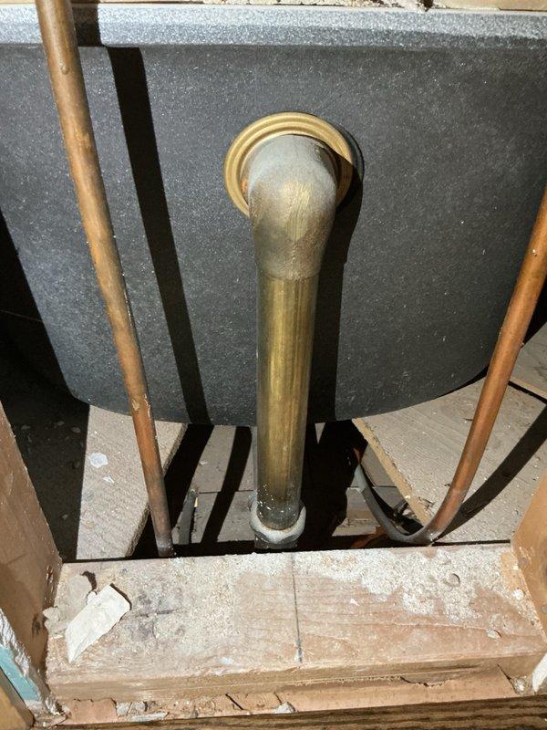 Responded to a slow-draining bathroom tub issue caused by a deteriorated overflow assembly. Removed the old overflow and drain components and installed new replacement parts to restore proper drainage function. System tested successfully upon completion with water now draining at normal rate.